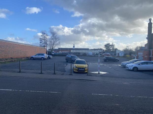 small car park with a few cars parked.