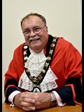 smiling man in mayoral robes